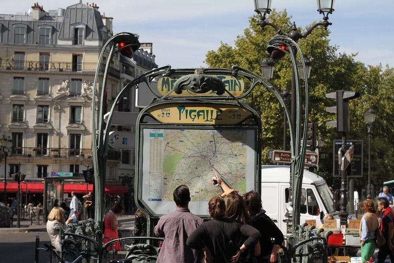 people looking at paris metro map