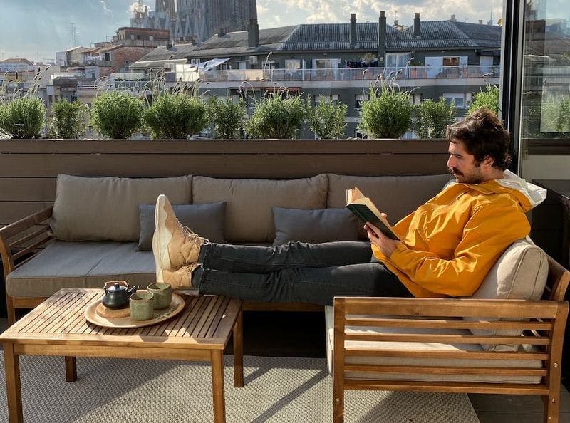 Man reading on rooftop terrace