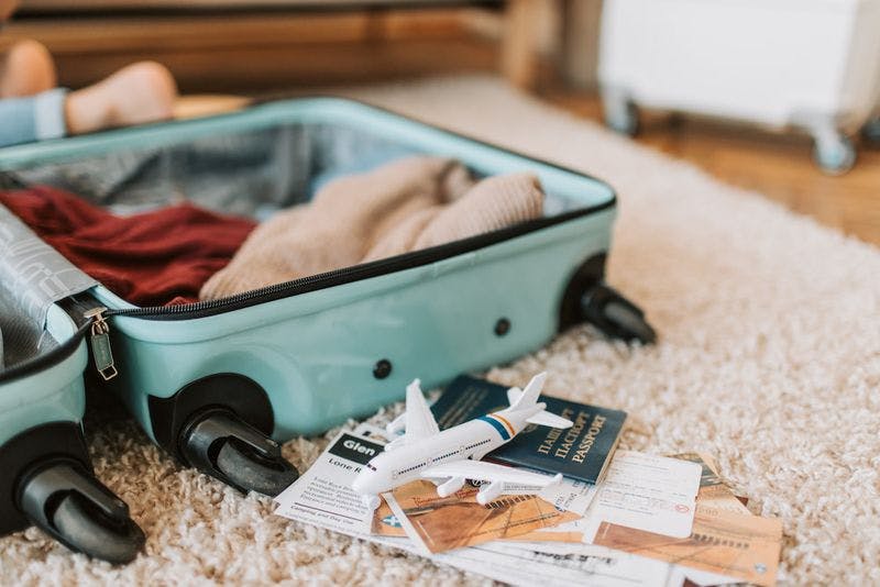 open suitcase with travel documents