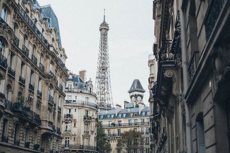 paris streets with white buildings and eiffel tower in the background