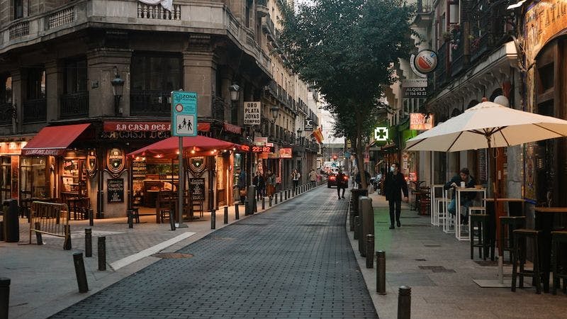 street in madrid with outdoor seating
