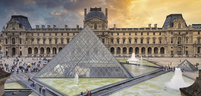 the louvre pyramid and buildings in background