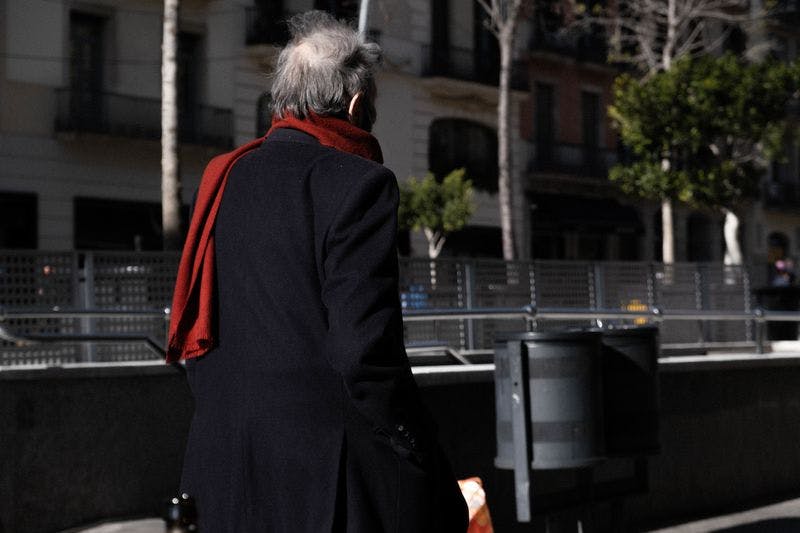 old man in scarf in barcelona winter
